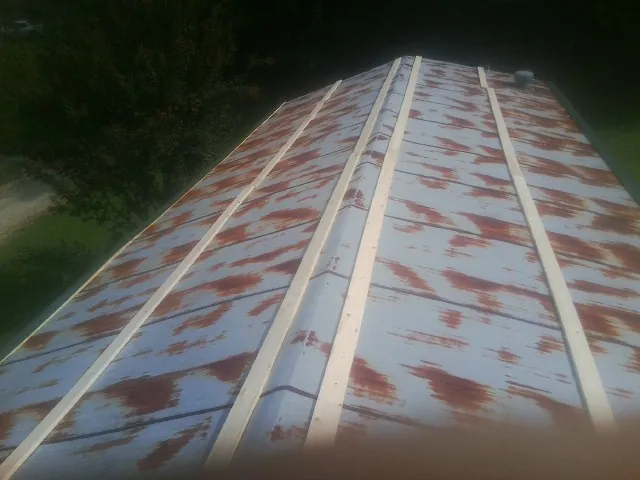 Rusted metal roof panels with new wood purlins before replacement — Storm Damage Roof Repair in Hortense by Roofing Brothers